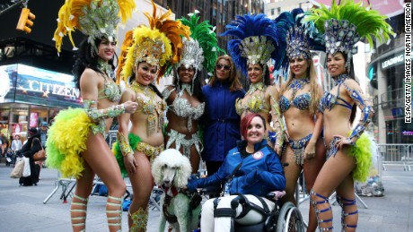  Paralympic equestrian star Sydney Collier poses with samba dancers during Team USA&#39;s Road to Rio Tour event.