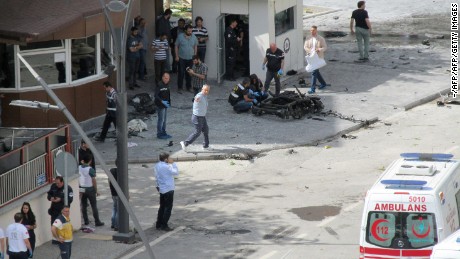 Police officers examine the scene outside the police headquarters in Gaziantep after the blast.