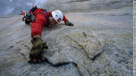 CANADA - JUNE 11:  Alex Lowe reaches up to feel which tool will hold his weight, Great Sail Peak, Baffin Island, Nunavut, Northwest Territories, Canada  (Photo by Gordon Wiltsie/National Geographic/Getty Images)