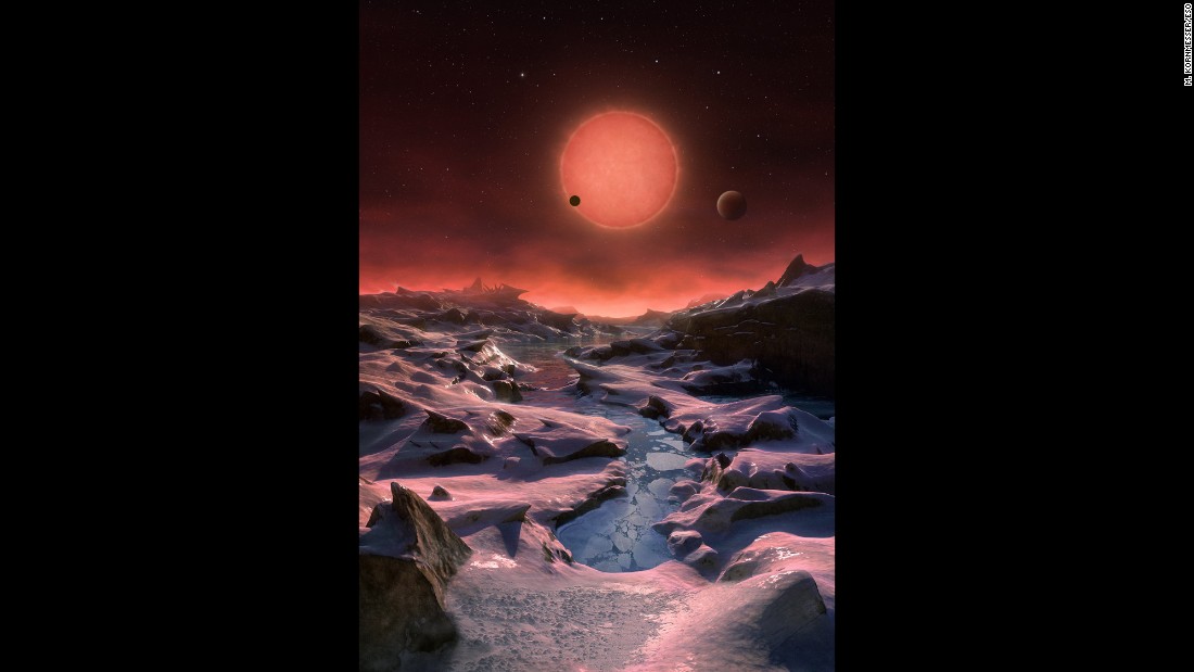 This artist&#39;s impression shows an imagined view from the surface one of the three planets orbiting an ultracool dwarf star just 40 light-years from Earth that were discovered using the TRAPPIST telescope at ESO&#39;s La Silla Observatory. Given the proximity of the dwarf star, the rosy sun would appear very large in the sky. 