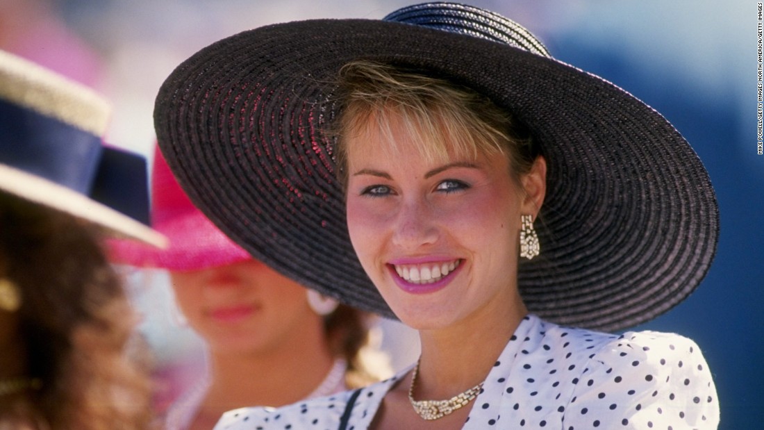 In the 1980s, the bigger the better. Big hat brims, big shoulder pads, and judging by this race-goer, a big smile. 
