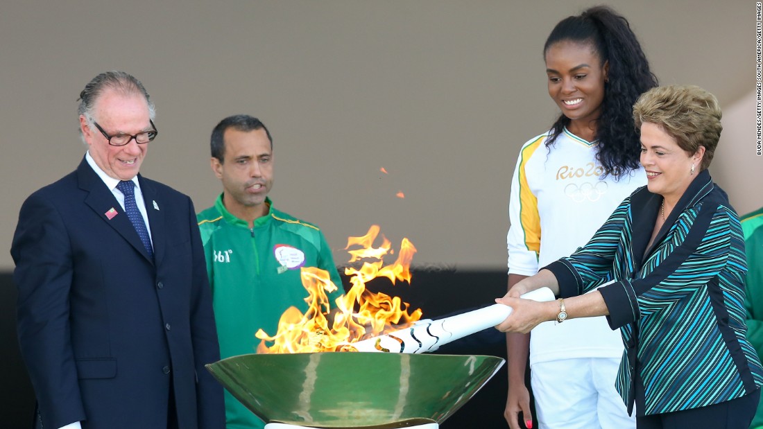 Brazilian president Dilma Rousseff lit the Olympic torch in Brasilia Tuesday. The  torch will pass through 329 cities on its way to Rio de Janeiro where the Games begin on August 5.