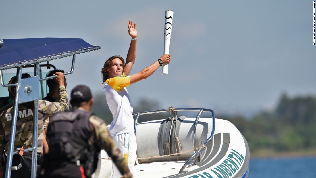 Brazilian sailor Felipe Rondina carried the Olympic flame on a speedboat at Lake Paranoa.