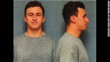 Heisman Trophy winner Johnny Manziel turned himself in to the Highland Park Police Wednesday afternoon on charges of domestic violence stemming from an incident at a Dallas hotel on Janaury 29, according to Lt. Lance Koppa with the Highland Park Dept of Public Safety.