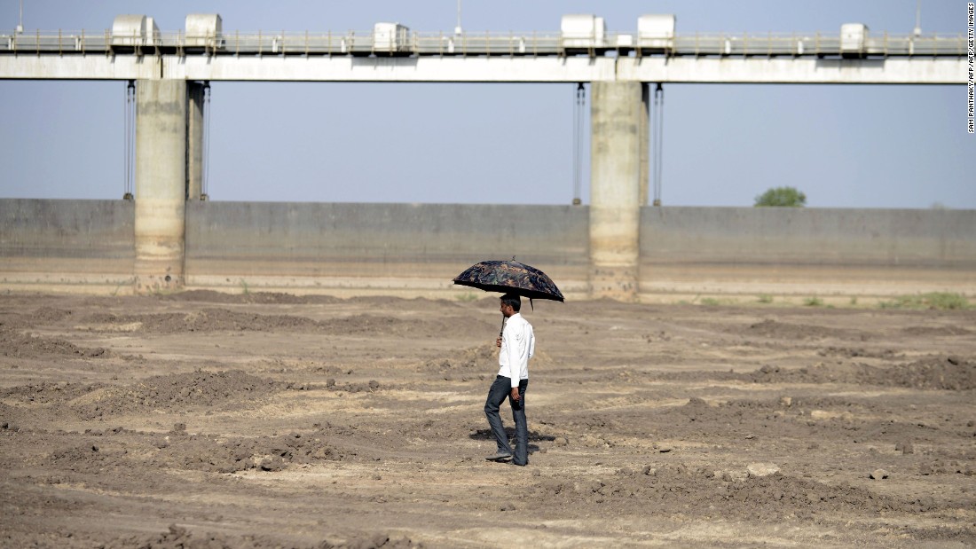 A man walks on the dry reservoir bed next to Gunda Dam in India&#39;s western Gujarat state on Friday, April 1.