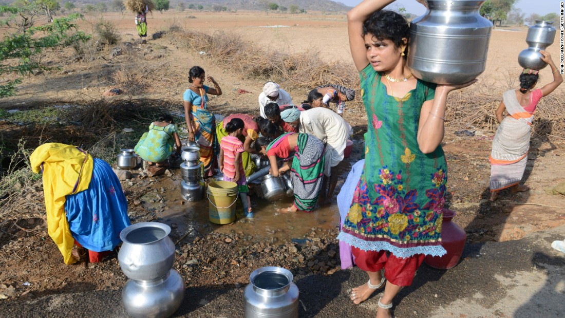 Villagers fill drinking water from a leaking roadside pipe in Nalgonda on April 25.