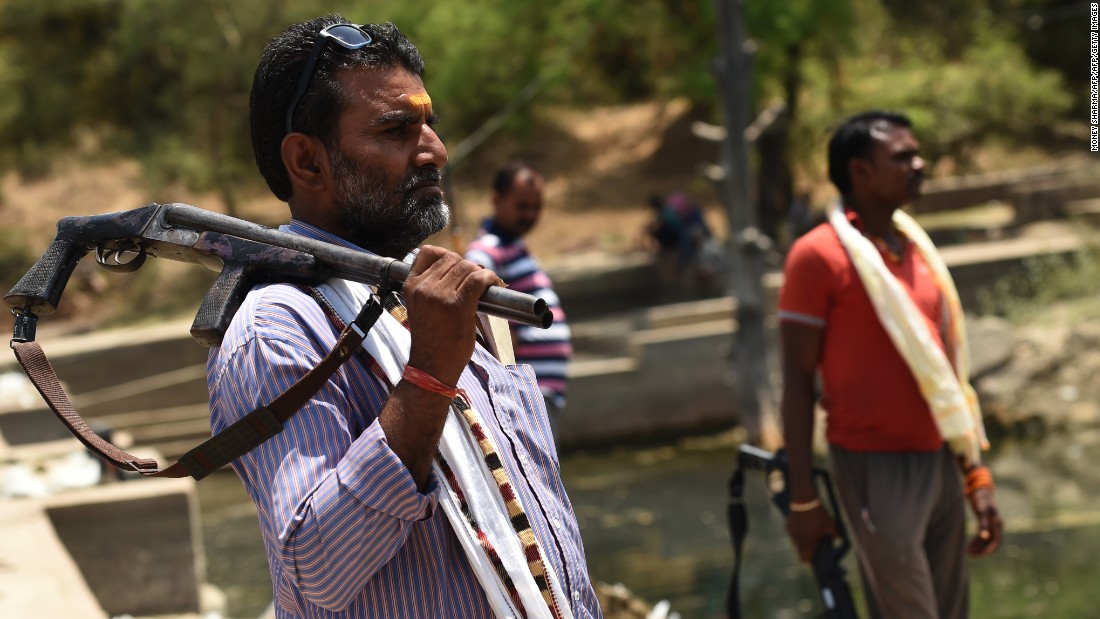India was hit by the worst drought in decades in 2016. Here, gunmen stand alert at a water reservoir in Tikamgarh, India, on April 27.
