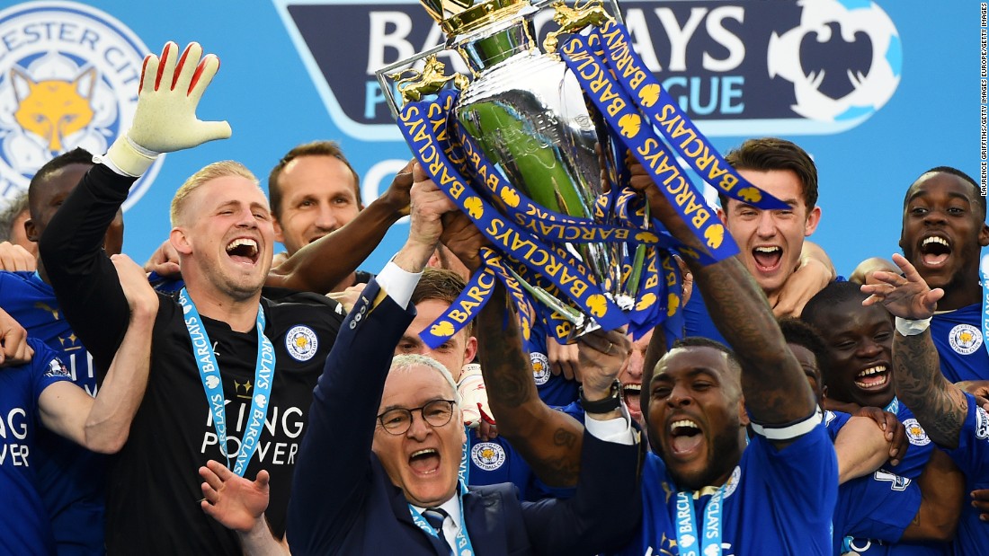 Captain Wes Morgan and manager Claudio Ranieri of Leicester City lift the Premier League trophy after defeating Everton 3-1.