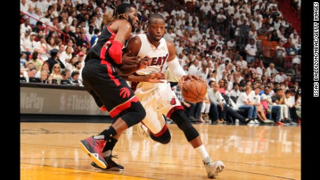 Miami Heat guard Dwyane Wade drives past Raptors forward DeMarre Carroll in Game 3 of their playoff series Saturday. 