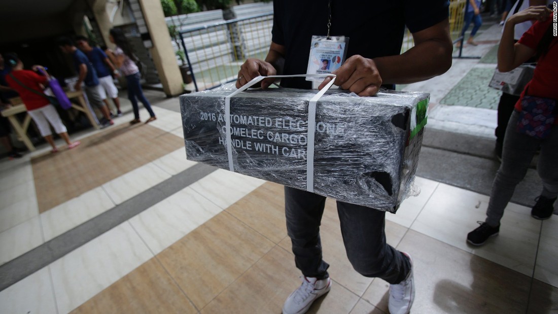 An election worker carries official ballots as they are distributed to polling centers in the suburban Quezon City, north of Manila on May 8, 2016. 