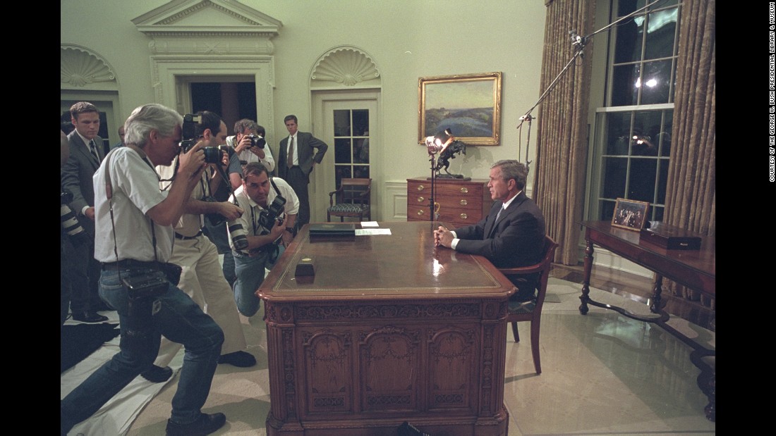 Bush pauses for members of the press before addressing the nation from the Oval Office.