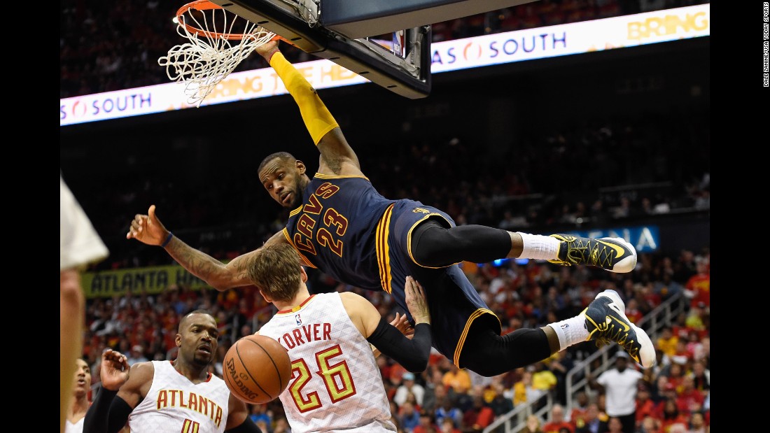 Cleveland&#39;s LeBron James dunks over Kyle Korver during an NBA playoff game in Atlanta on Friday, May 6. The Cavs swept the Hawks to advance to the Eastern Conference finals.