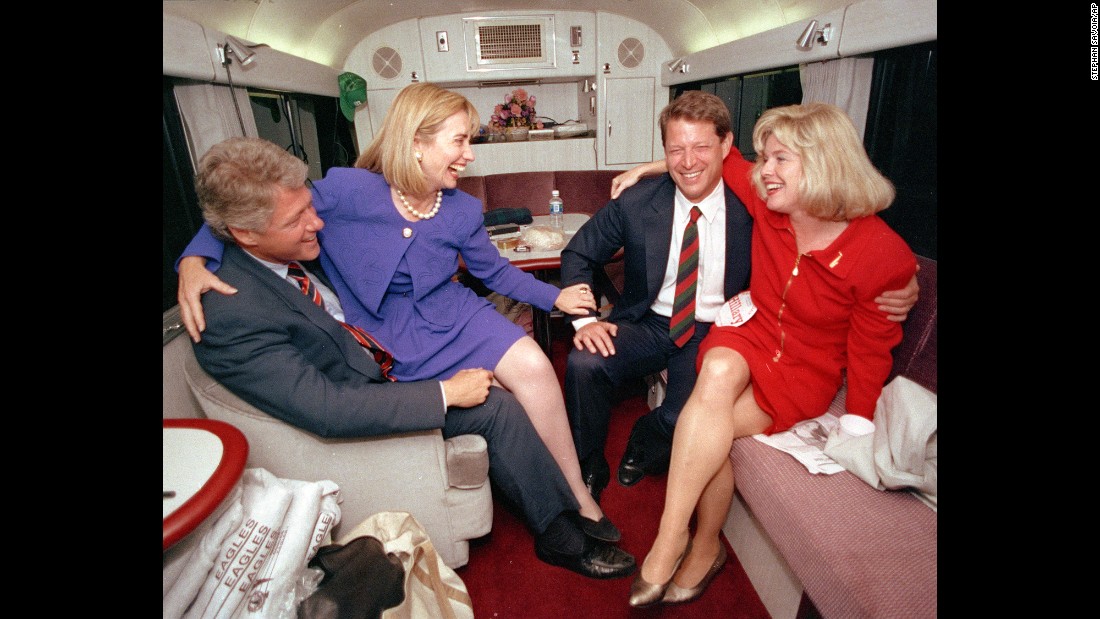 During the 1992 presidential campaign, Clinton jokes with her husband&#39;s running mate, Al Gore, and Gore&#39;s wife, Tipper, aboard a campaign bus.