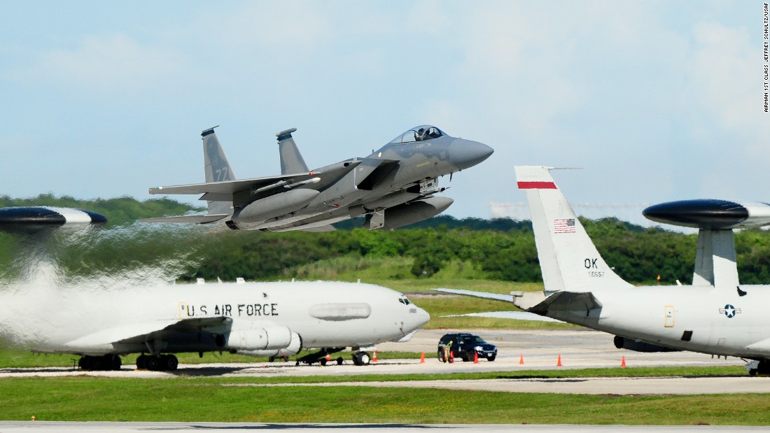 An F-15 Eagle takes off from the Andersen Air Force Base, Guam, flight line as two E-3 Sentries are seen in the background.