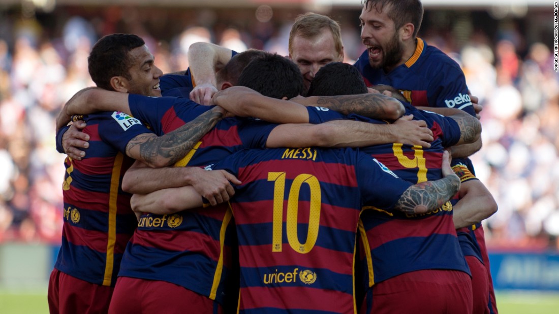 Barcelona&#39;s players celebrate a 24th La Liga title after a 3-0 win at Granada.