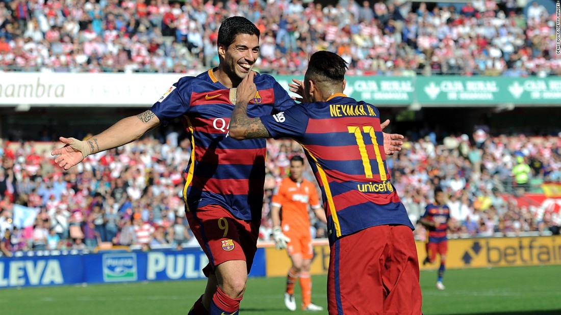 Suarez embraces Neymar after completing his hat-trick at Granada and his 40th league goal of the season.