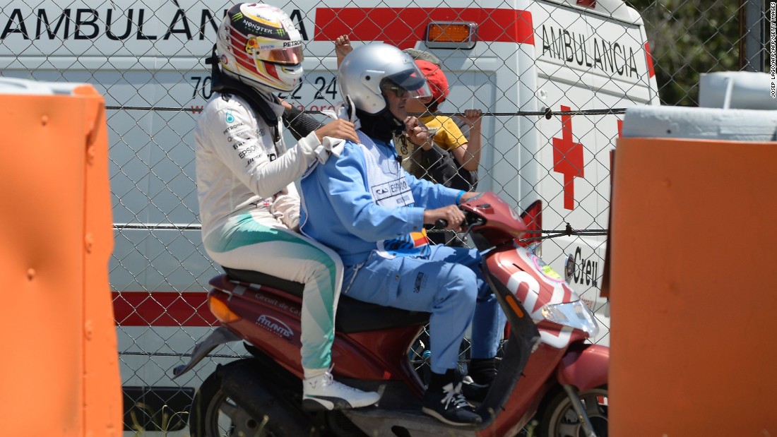 Hamilton swapped four wheels for two, as he was escorted back to Mercedes&#39; base on a scooter following the crash.