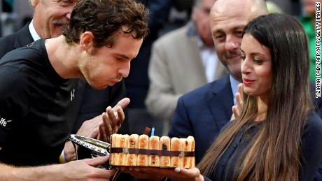Murray is given a cake after his win to celebrate his 29th birthday