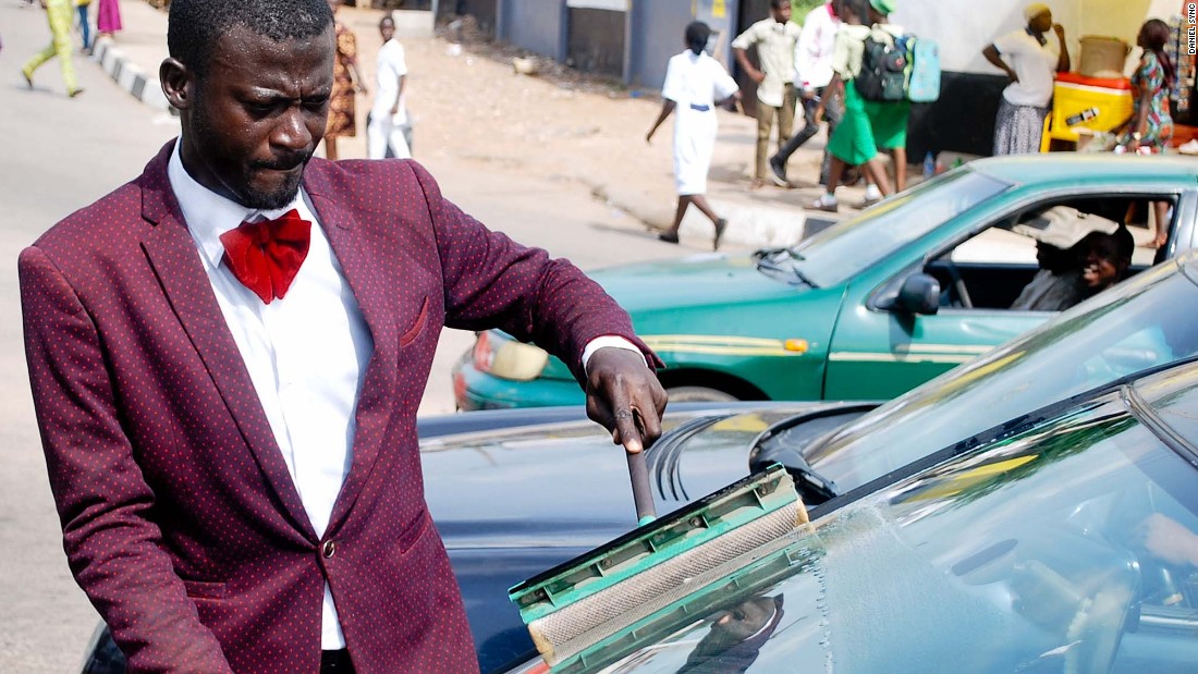 Abdulahi Olatoyan wears sharp suits while working as a car window washer in Abeokuta, southwest Nigeria. &quot;I didn&#39;t want to be wandering around the streets doing nothing&quot; he says. 