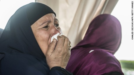 A relative of a passenger who was flying aboard an EgyptAir plane that vanished from radar in route from Paris to Cairo overnight cries as family members are transported by bus to a gathering point at Cairo airport on May 19. 