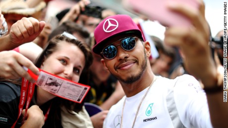 Reigning world champion Lewis Hamilton takes a selfie with fans at the Spanish GP.  