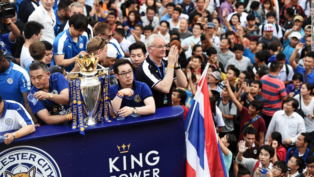 Leicester City manager Claudio Ranieri (center) gives a traditional Thai &quot;wai&quot; gesture of welcome as fans of the English Premier League soccer champions greet the Thai-owned team in Thailand&#39;s capital, Bangkok. Ranieri steered Leicester, owned by billionaire businessman Vichai Srivaddhanaprabha, to the most unlikely triumph in Premier League history as it won the competition by 10 points from second-placed Arsenal. Jon Sanders, the Leicester player liaison officer, &lt;a href=&quot;http://www.leicestermercury.co.uk/Leicester-City-parade-Premier-League-trophy/story-29294144-detail/story.html&quot; target=&quot;_blank&quot;&gt;told the Leicester Mercury newspaper&lt;/a&gt;: &quot;One million people on the streets to welcome the Premier League champions in Bangkok. Incredible.&quot;