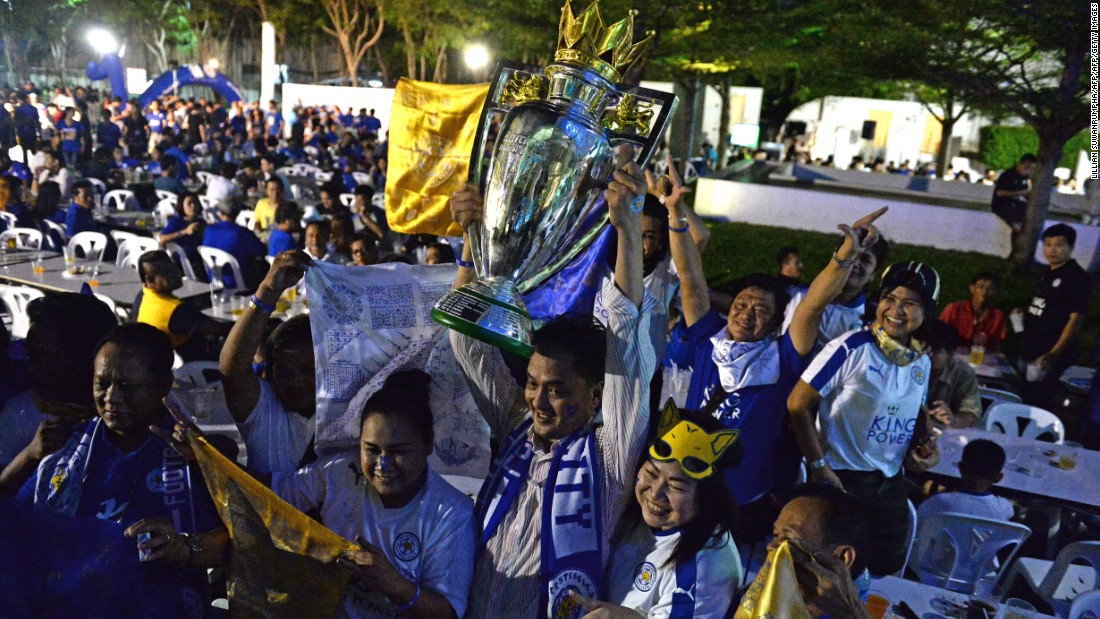 Leicester fans in Bangkok pose with a replica Premier League trophy before a live screening of the Leicester vs. Everton match on the penultimate weekend of the Premier League season. Leicester, confirmed as champion when rival Tottenham failed to win earlier that week, triumphed 3-1 to add even more gloss to their remarkable triumph.