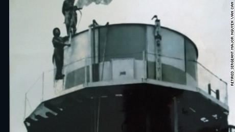 Ret. Sergeant Major Nguyen Van Can (below) and his comrade raise the liberation flag on top of the water tower at Tan Son Nhat airport.