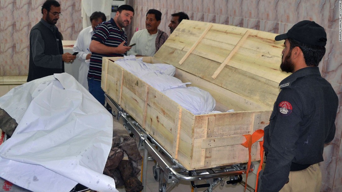 Pakistani security officials and hospital staff oversee two bodies at the Quetta morgue on May 22.