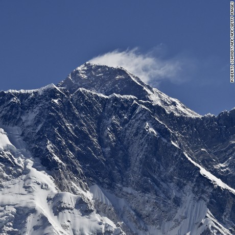 This photograph taken on April 20, 2015 shows a view of Mount Everest (C-top) towering over the Nupse, from the village of Tembuche in the Khumbu region of northeastern Nepal.  Sherpas, thought to be of Tibetan origin, have a long and proud history of mountaineering, and the term today is used for all Nepalese high-altitude porters and guides assisting climbing expeditions around Everest. The April 25 quake, which left more than 7,800 people dead across Nepal, was the Himalayan nation&#39;s deadliest disaster in over 80 years, and triggered an avalanche which killed 18 people on Everest, leading mountaineering companies to call off their spring expeditions, marking the second year with virtually no summits to the roof of the world.      AFP PHOTO / ROBERTO SCHMIDT        (Photo credit should read ROBERTO SCHMIDT/AFP/Getty Images)