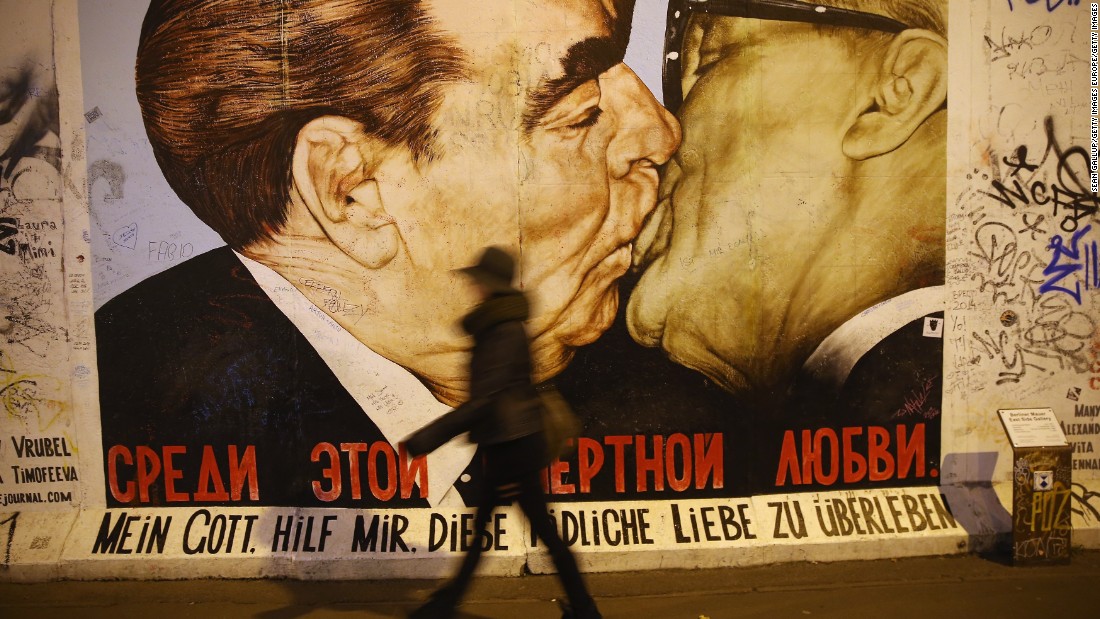 The mural is a play on a famous work of art on the Berlin wall depicting Soviet leader Leonid Brezhnev and East German leader Erich Honecker sharing a kiss. The message below reads: &quot;My God, help me survive this deadly love.&quot;