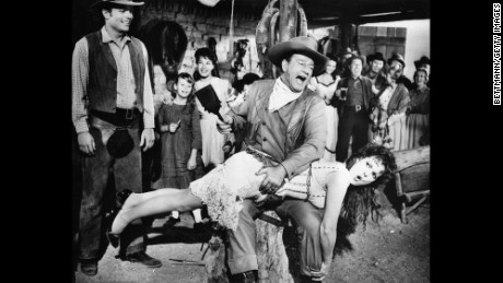 John Wayne, playing George McLintock, spanks Maureen O'Hara, playing his wife Katherine, in the Western-comedy McLintock!