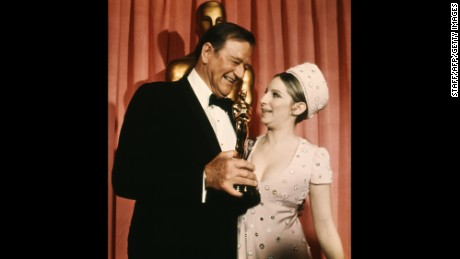 John Wayne with his Oscar and Barbra Streisand