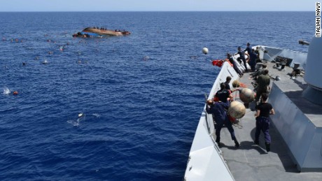 Rescuers try to save migrants from a capsized boat off Libya on Wednesday. Another boat capsized Thursday.
