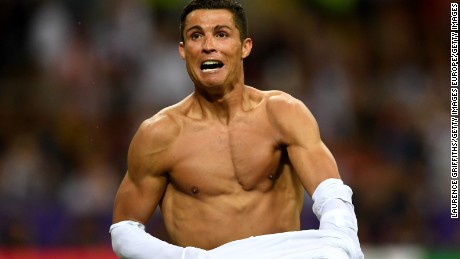 MILAN, ITALY - MAY 28:  Cristiano Ronaldo of Real Madrid takes off his shirt in celebration after scoring the winning penalty in the penalty shoot out during the UEFA Champions League Final match between Real Madrid and Club Atletico de Madrid at Stadio Giuseppe Meazza on May 28, 2016 in Milan, Italy.  (Photo by Laurence Griffiths/Getty Images)