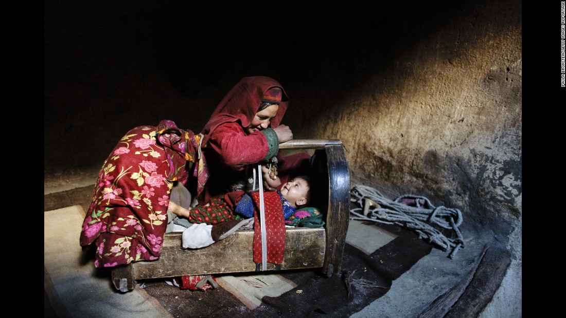 A mother tends to her son inside their home in Afghanistan&#39;s &lt;a href=&quot;http://cnnphotos.blogs.cnn.com/2014/06/22/on-top-of-the-world-untouched-by-war/&quot; target=&quot;_blank&quot;&gt;Wakhan Corridor&lt;/a&gt; in October 2007.