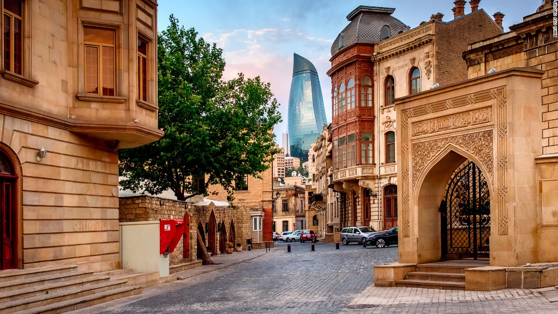Baku prides itself on being a city that combines the historic and modern. Here, one of the city&#39;s famous Flame Towers peeps between the walls of the old city.
