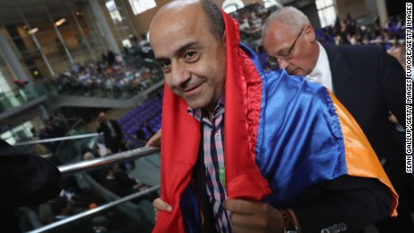 A visitor wars the Armenian flag during the parliament vote. 
