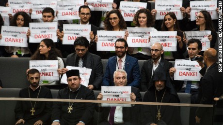 Armenian clergy men and activists hold up signs saying &quot;thank-you&quot; after the vote.  