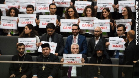 Armenian clergy and activists react after German lawmakers vote to recognise the Armenian genocide after a debate in the Bundestag in Berlin on June 2, 2016.