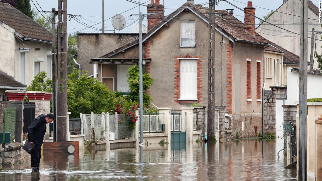 A man maneuvers through a flooded street in Nemours, south of Paris, on June 3.