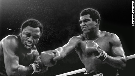 Muhammad Ali connects with a right during his &quot;Thriller in Manila&quot; bout against Joe Frazier.