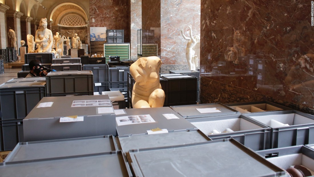 Plastic boxes containing artworks are placed between sculptures for safe-keeping in an exhibition hall at the Musée du Louvre on June 3. 