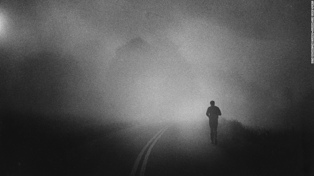 Ali takes his daily run along a Pennsylvania country road, shrouded in early morning fog, in 1978.