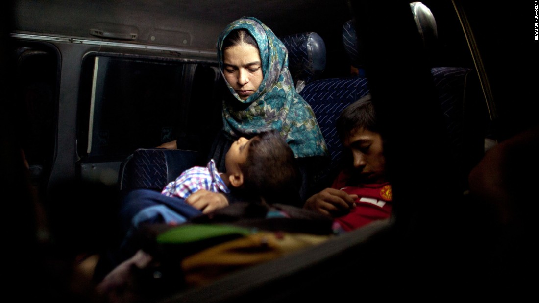A boy sleeps in his mother&#39;s arms after fleeing from their home in Falluja on Monday, June 6.