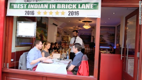 Diners choose from a long list of curries on London&#39;s Brick Lane. 