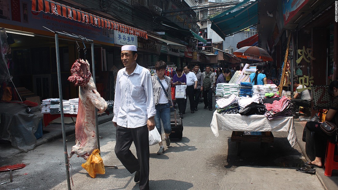 After slaughtering this lamb on street, the Uygur restaurateurs from north-west China hang the meat ready to cook for customers.
