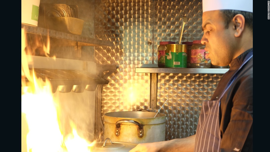 Head chef of the Shaad restaurant Mohammad Anam Hussain cooks a chick pea curry.