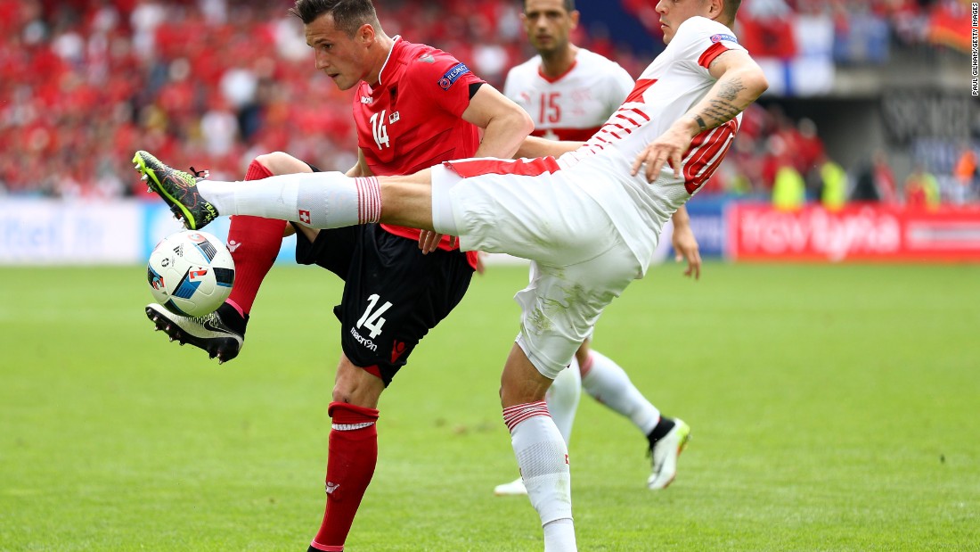 Brothers Taulant Xhaka of Albania and Granit Xhaka of Switzerland compete for the ball.