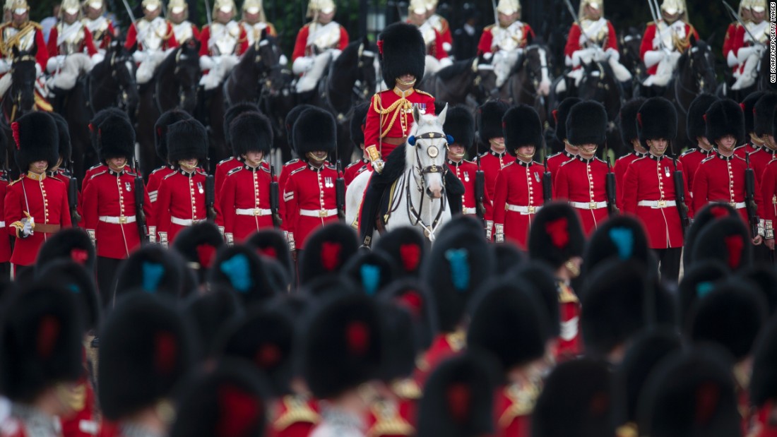 Members of The Foot Guards and The Household Cavalry march. The monarch is technically the head of Britain&#39;s armed forces, and would traditionally lead an army into war. The parade gives the Queen a chance to review and approve her army.